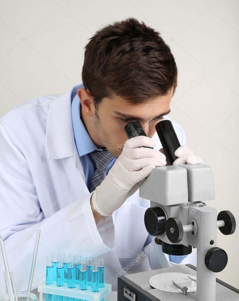 depositphotos_30617275-stock-photo-young-laboratory-scientist-looking-at